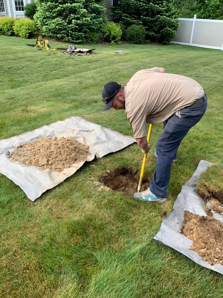 man digging in a yard fro septic service