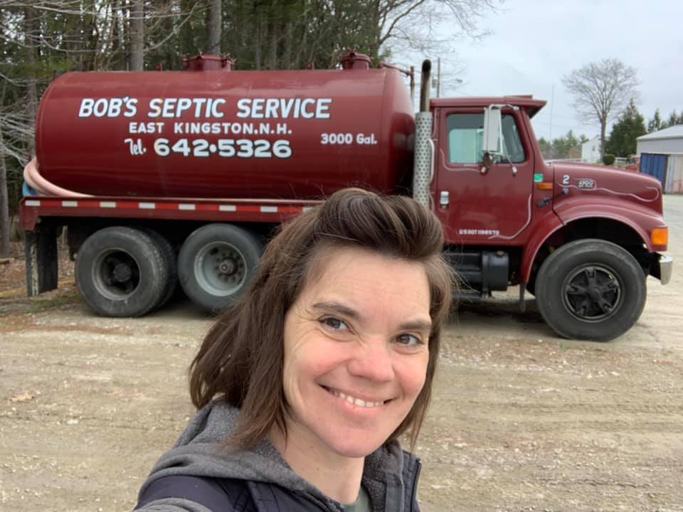 Woman in front of Bobs Septic Service truck
